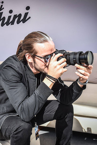 Professional automotive photographer using Auto AI Studio for client work